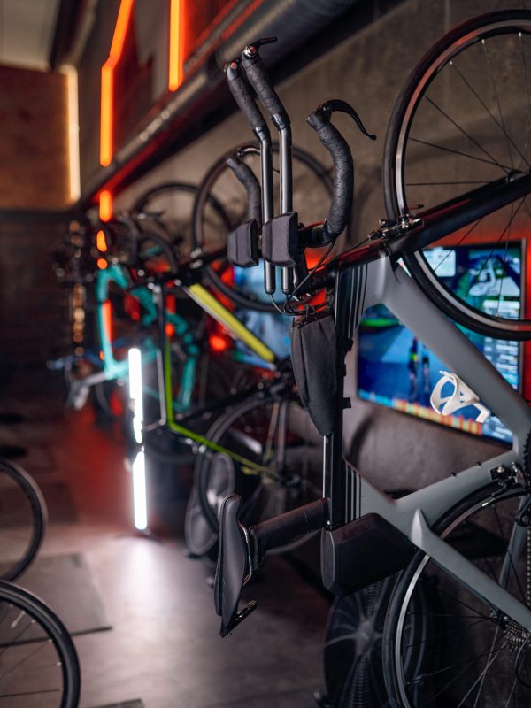 Aerobics spinning exercise training bike in row at gym room. Fitness stationary machine for athletic cardiovascular workout